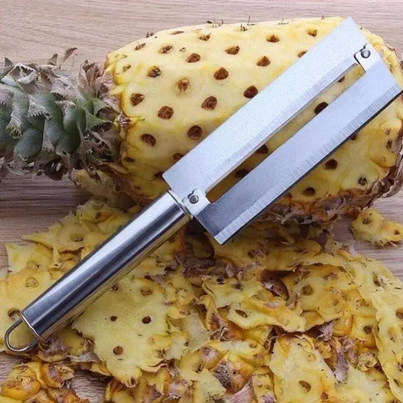 Stainless Steel Fruit Tools - Peeling & Slicing Set showing a pineapple peeler tool next to a peeled pineapple.