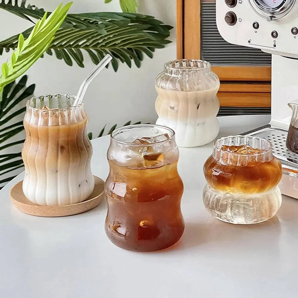 Ripple Drinking Glasses | Artistic Design Glasses featuring iced coffee and tea in ribbed, origami-inspired glassware on a white table.