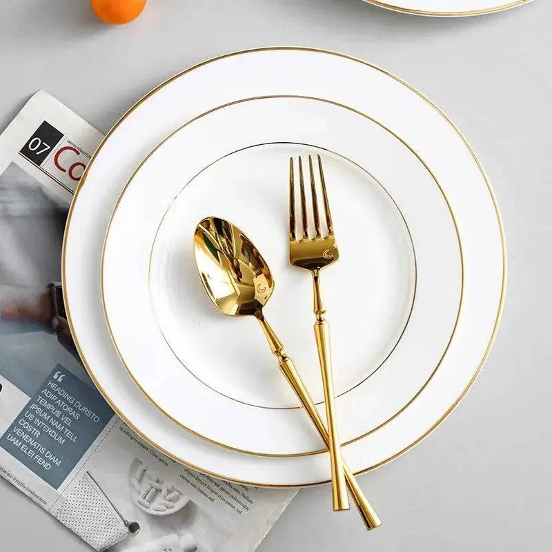 Onlycook Steak Plate - Luxury Dining Experience | Durable, Chic; elegant white ceramic plate with gold trim, paired with gold cutlery on a table.