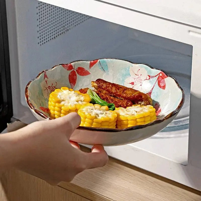 700 ML Flowers Ceramic Bowl with floral design being placed in a microwave, highlighting its heat-resistant and versatile features.