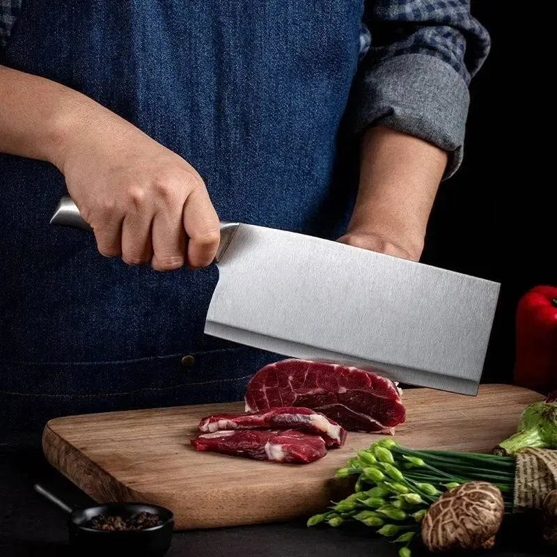 Stainless Steel Kitchen Knives Set - Precision Cutting featuring a chef slicing raw meat on a wooden board with a sleek stainless steel knife.