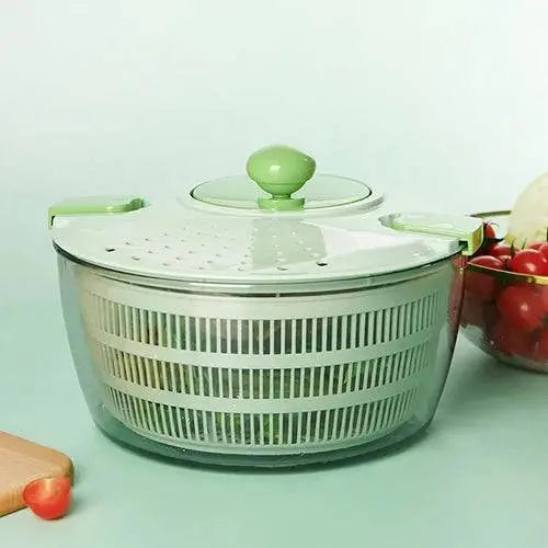Manual Vegetable Salad Spinner - Compact, Durable | Buy Now, stylish green salad spinner with transparent bowl, surrounded by fresh vegetables.