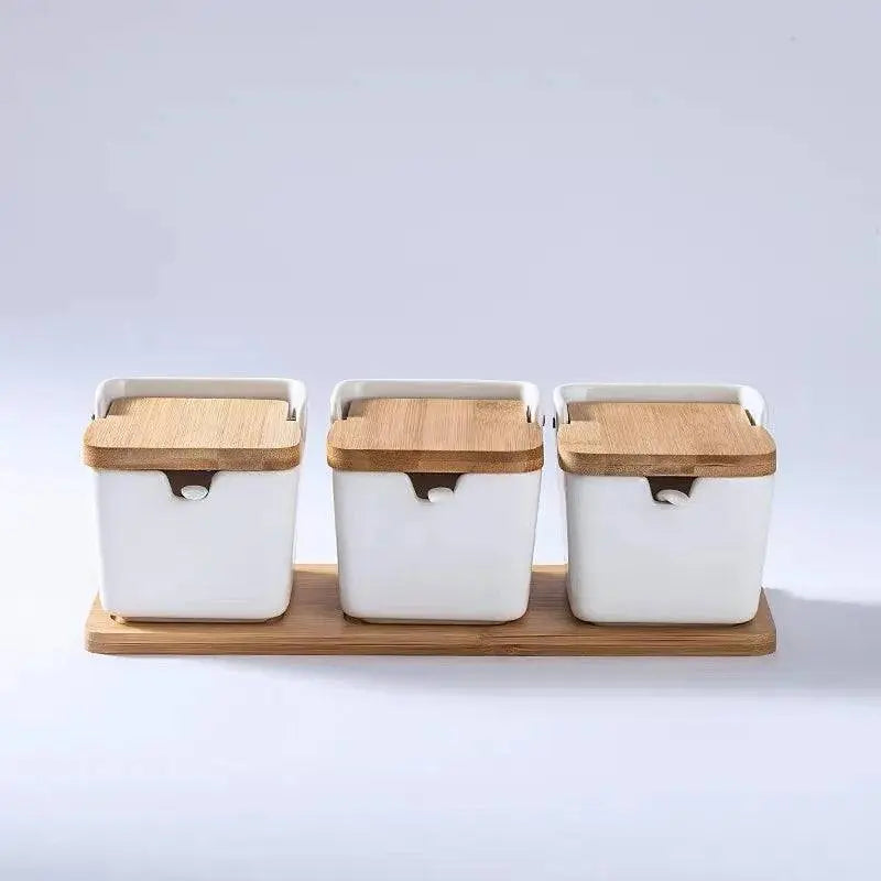 Minimalist Ceramic Spice Jar with Bamboo Lid | Compact & Airtight three white ceramic spice jars with bamboo lids on a bamboo tray.
