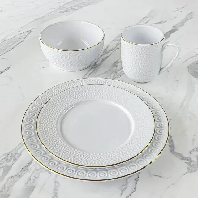 Sofia Vergara Stoneware Set showcasing a white embossed dinner plate, salad plate, bowl, and mug, ideal for stylish and durable dining.