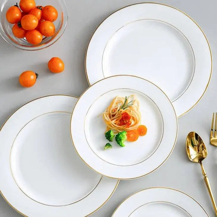Onlycook Steak Plate - Luxury Dining Experience | Durable, Chic; set of white ceramic plates with gold rims, displayed with pasta and vegetables.