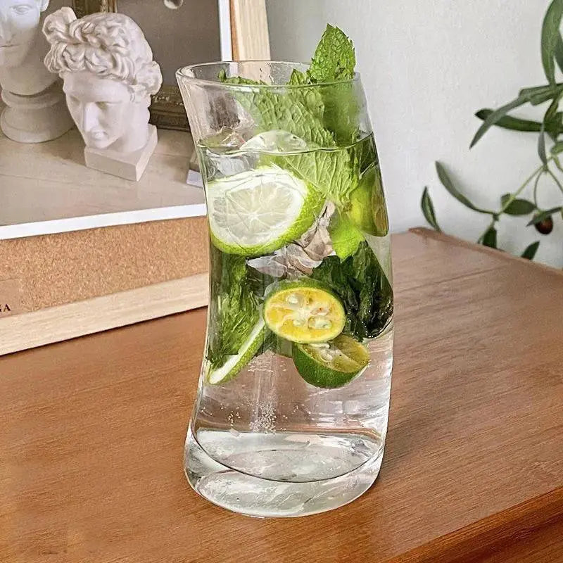 Transparent Glass Cup - Stylish Design | Microwave Safe, showcasing a refreshing lime and mint water, elegant curved silhouette perfect for beverages.