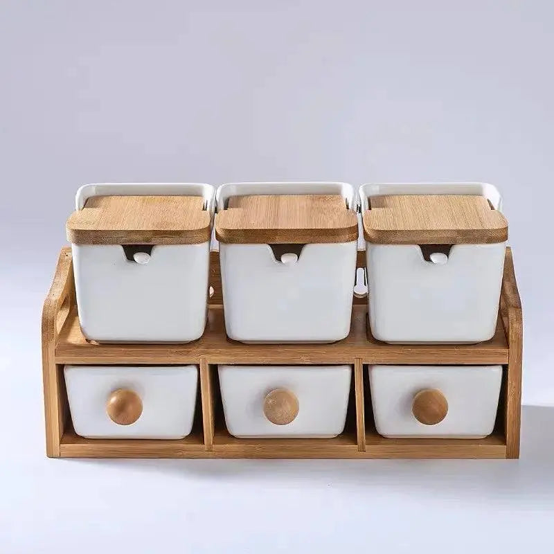 Minimalist Ceramic Spice Jar with Bamboo Lid | Compact & Airtight three white spice jars with bamboo lids on a wooden rack with drawers.