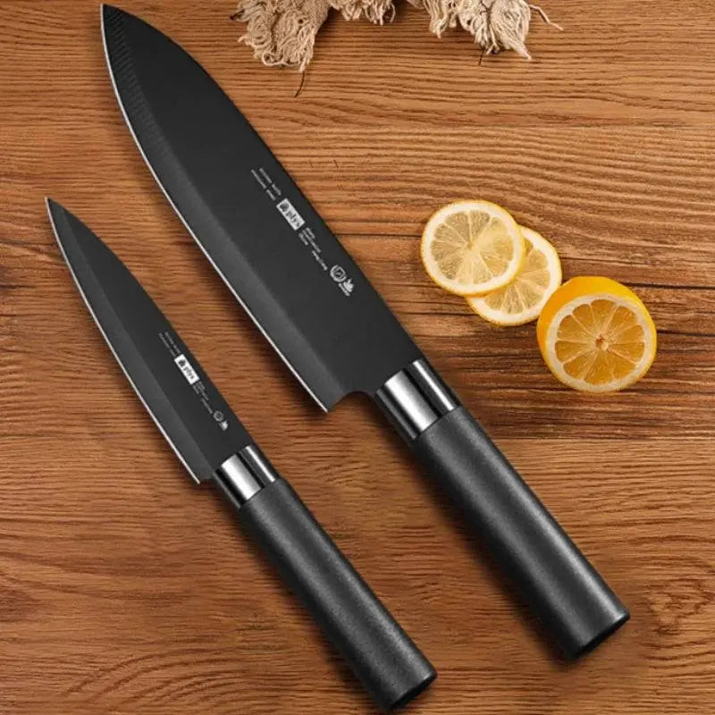 Two Chef's Fruit Knives with black stainless steel blades on a wooden surface, ideal for slicing fruits and preparing sushi.