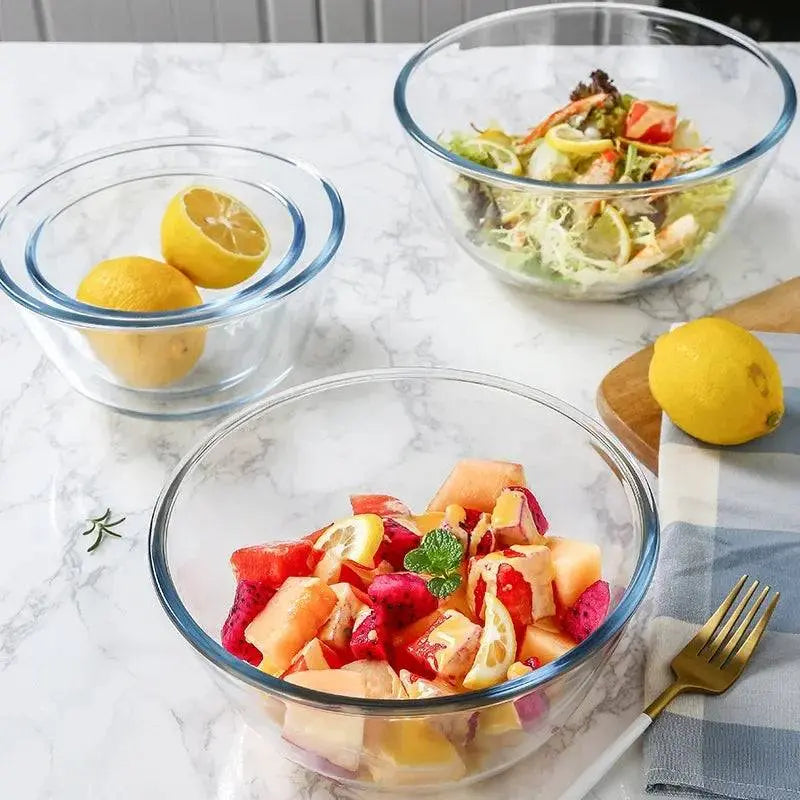 Multiple Glass Salad Bowls - Durable & Versatile Kitchen Essential displaying fresh fruits, salad, and lemons on a marble table.