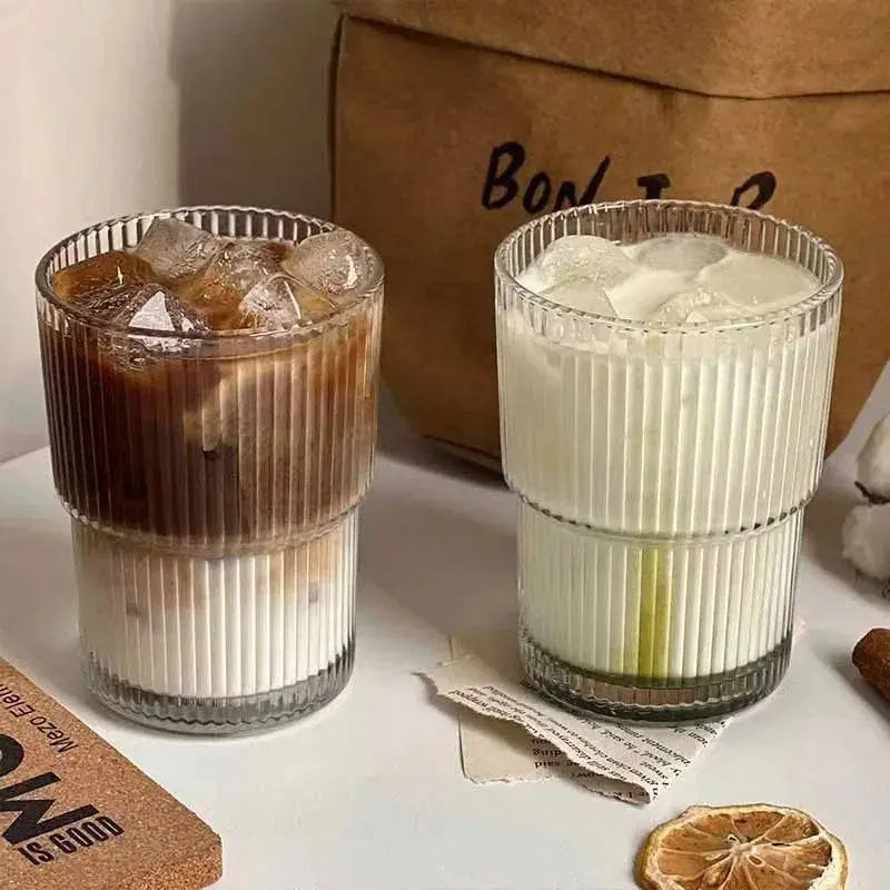 400 ML Stripe Glass Cup | Durable Transparent Design filled with iced coffee and milk drinks, emphasizing the stylish ribbed glass perfect for parties.