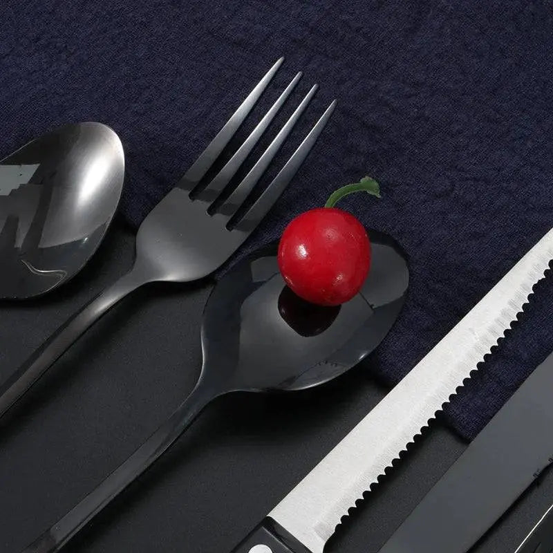 24 Pieces Stainless Steel Cutlery Set | Durable Dining Elegance featuring black stainless steel spoons, fork, and steak knife with a cherry on top.
