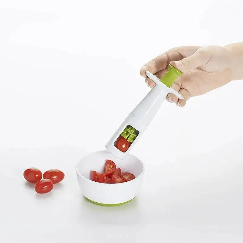 Hand using Handy Grape Cutter - Grape Cutter Tool | Safe Fruit Slicer to slice cherry tomatoes into a white bowl.