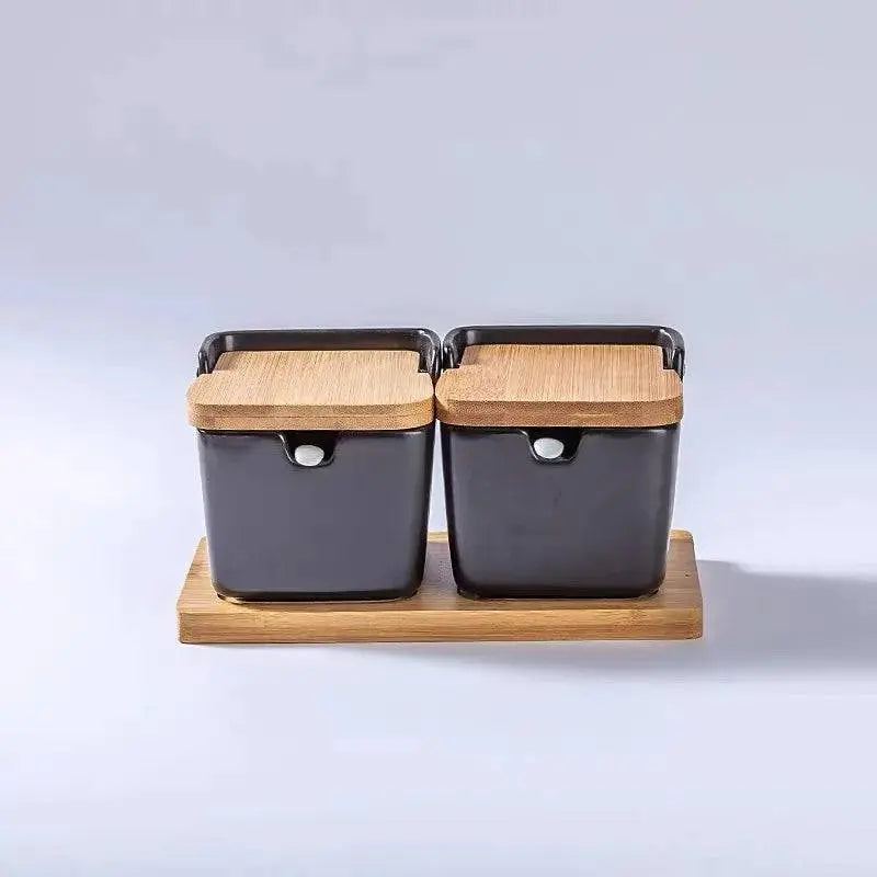 Minimalist Ceramic Spice Jar with Bamboo Lid | Compact & Airtight two black ceramic spice jars with bamboo lids placed on a bamboo tray.