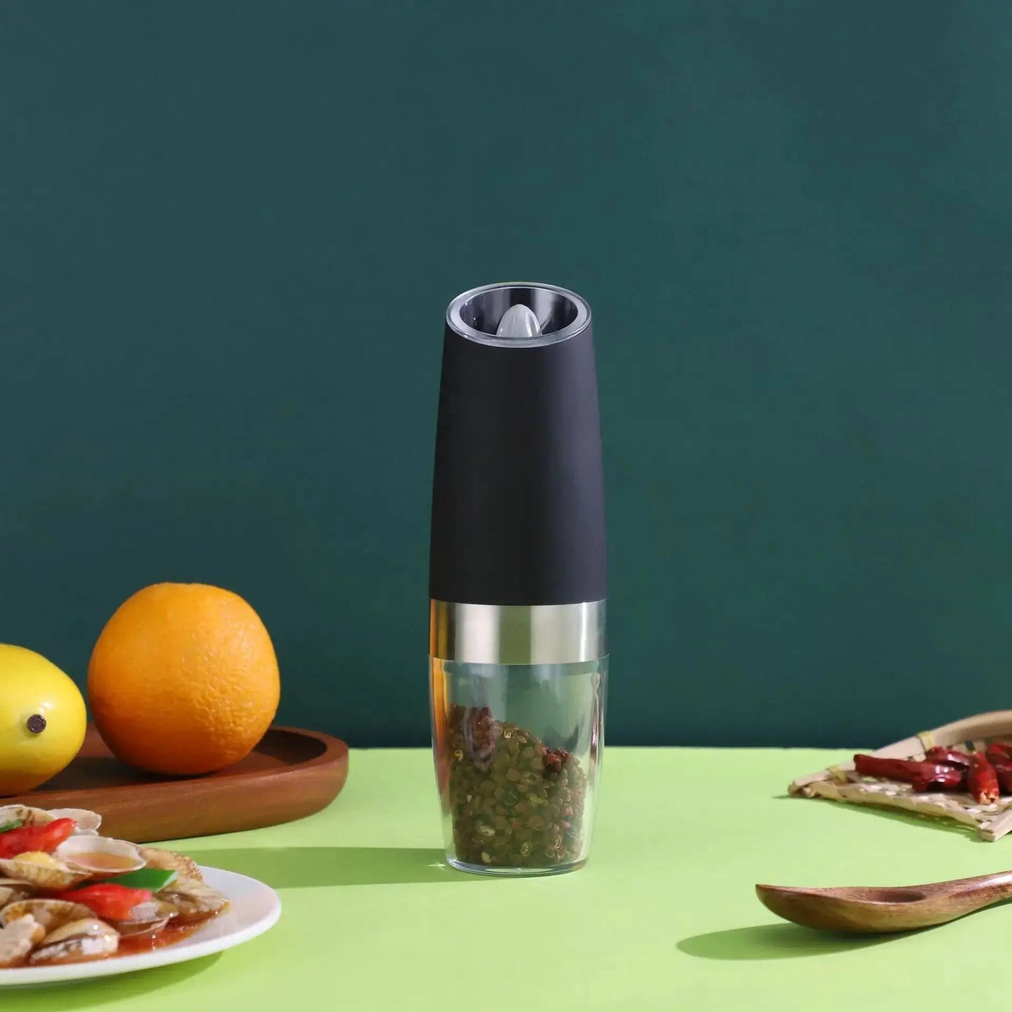 Single black Automatic Pepper Grinder - Electric Grinder on a green table, perfect for modern kitchens and effortless spice grinding.