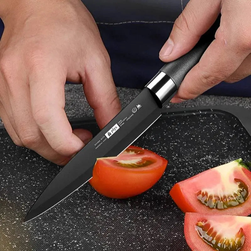 Chef's Fruit Knife slicing a tomato on a black cutting board, showcasing its precision and high-hardness stainless steel blade.