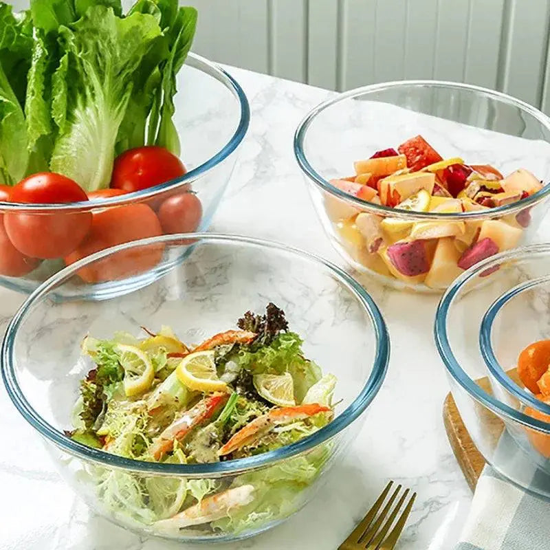 Set of Glass Salad Bowls - Durable & Versatile Kitchen Essential holding lettuce, tomatoes, fruits, and salad on a marble surface.