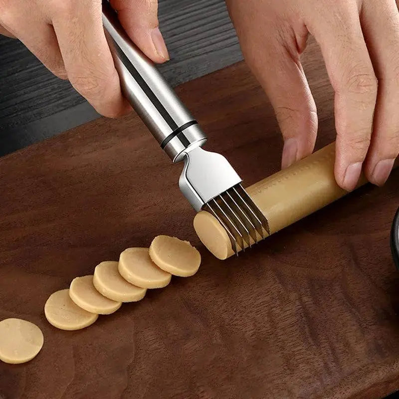 Stainless Steel Onion Cutter - Precision Grater | Quick Meal Prep tool slicing sausage into even pieces on a dark wooden cutting board.