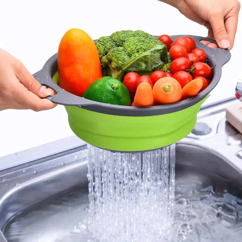 Round Folding Colander straining fresh vegetables over a sink, featuring a collapsible green design for efficient kitchen use.