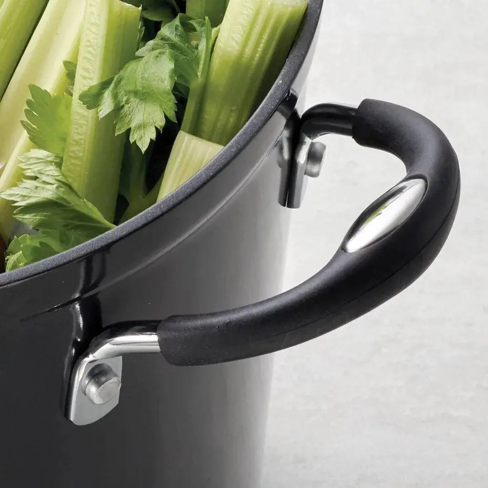 Close-up of Tramontina 8 Qt Non-Stick Stock Pot handle with celery inside, highlighting ergonomic grip and durable construction.