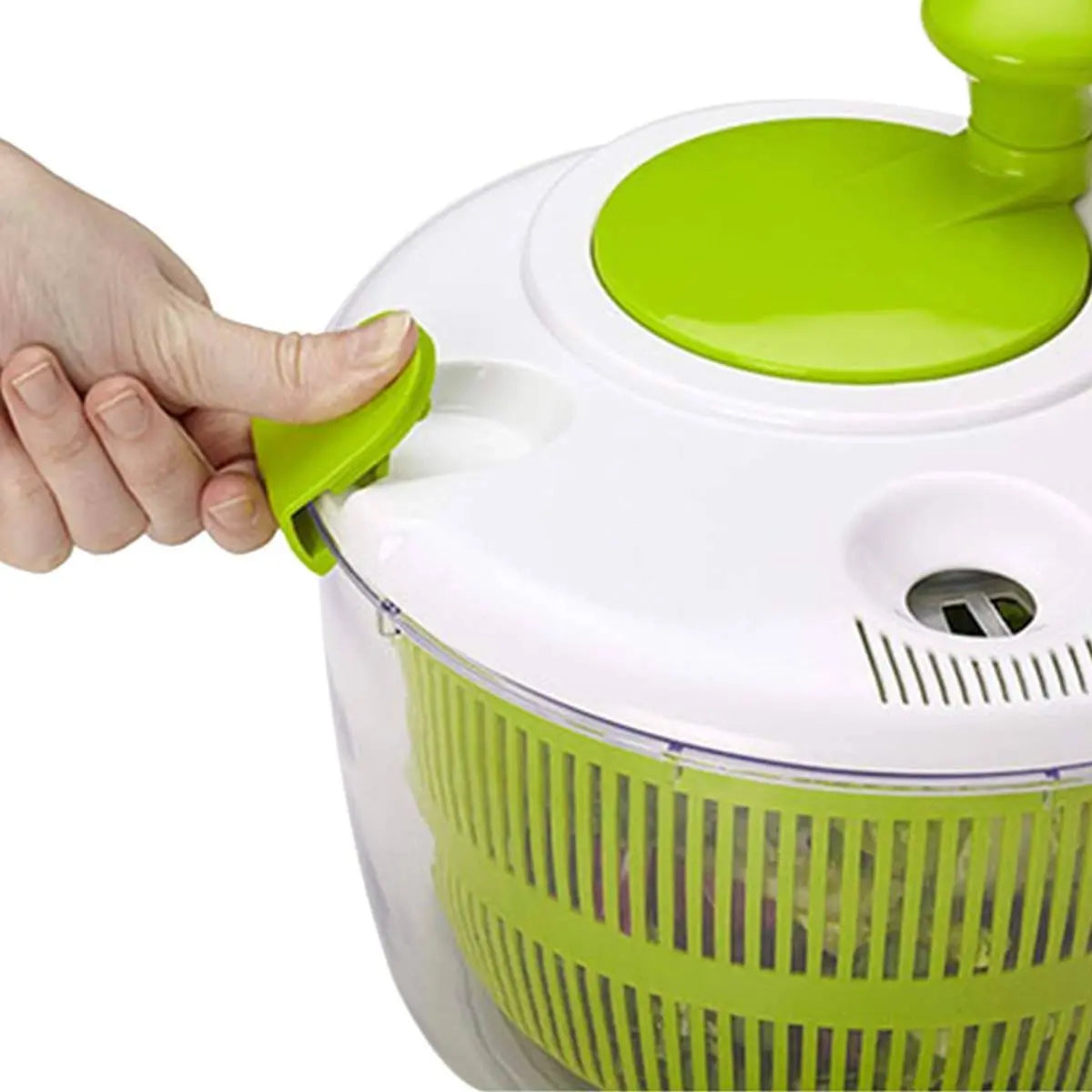 Manual Vegetable Salad Spinner - Compact, Durable | Buy Now, close-up of hand unlocking the green latch on the white lid for easy access.