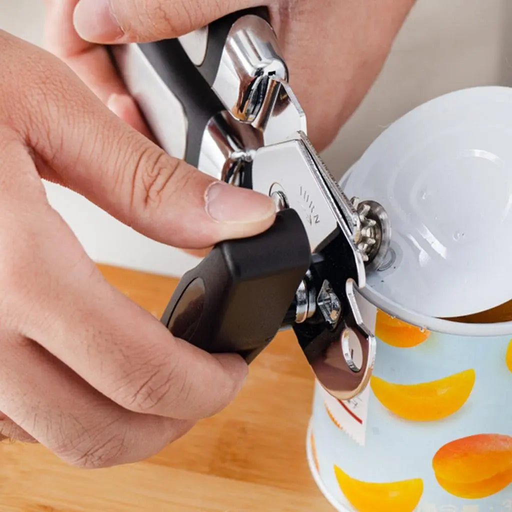 Professional Tin Manual Can Opener - Manual Can Opener | Ergonomic, Durable, Multifunctional being used to open a can of peaches with ease.