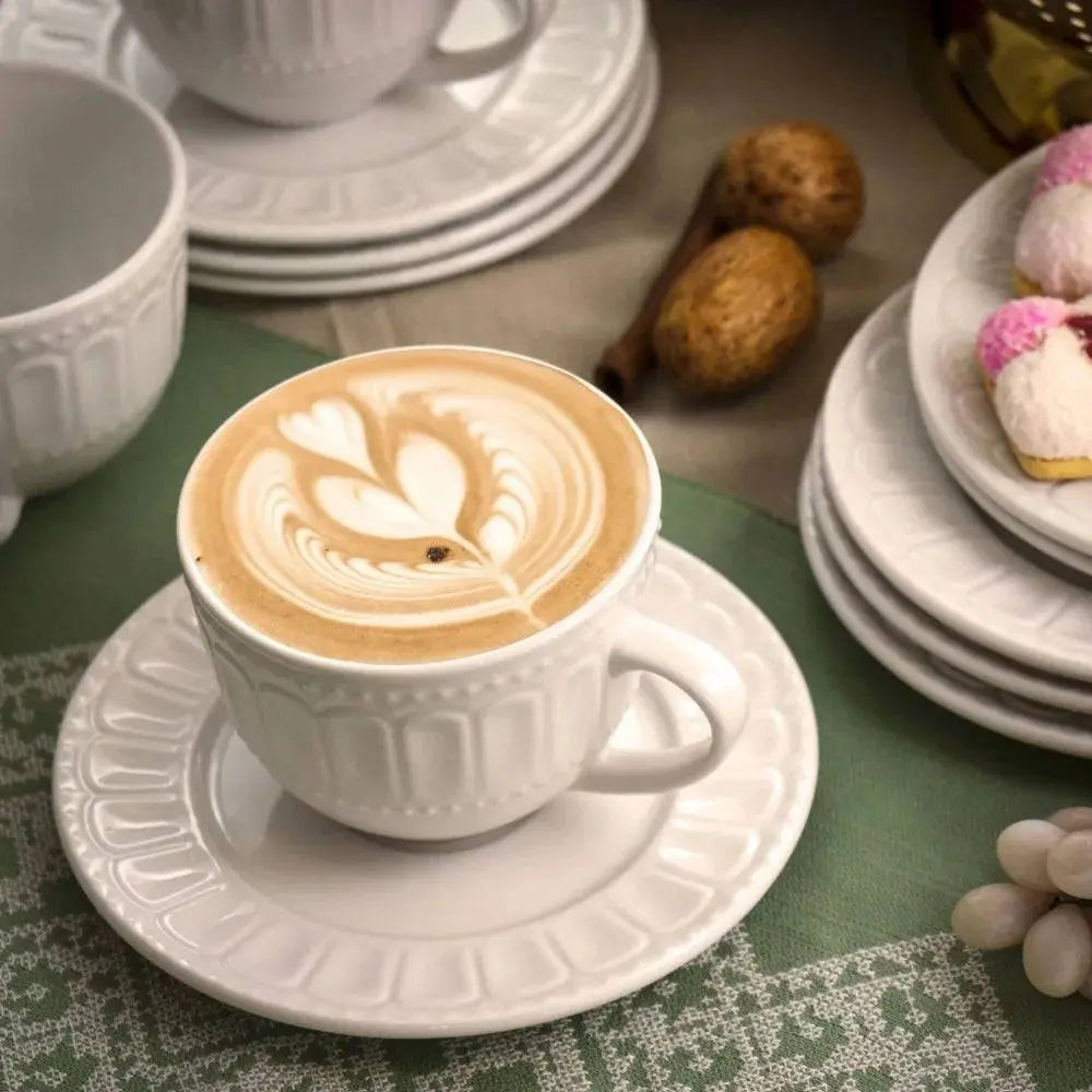 Charlotte Mug Set - Stylish & Durable Mugs | Microwave Safe, featuring a latte art coffee served in a white embossed mug with matching saucer and plates.