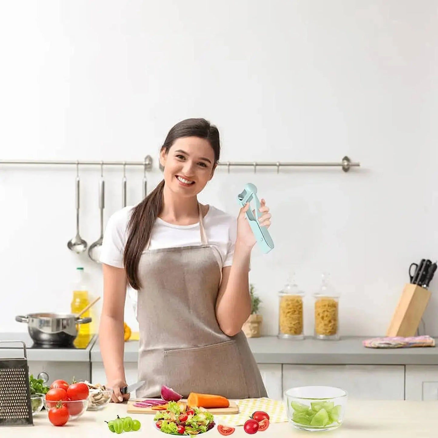 Woman holding Handy Grape Cutter - Grape Cutter Tool | Safe Fruit Slicer in a kitchen while preparing a fresh vegetable salad.