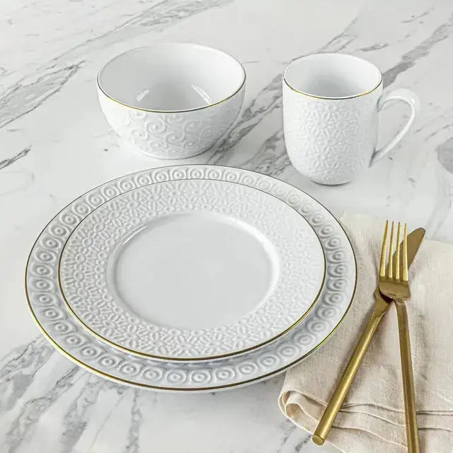 Sofia Vergara Stoneware Set featuring a white embossed plate, bowl, and mug with gold trim, perfect for elegant dining and microwave use.