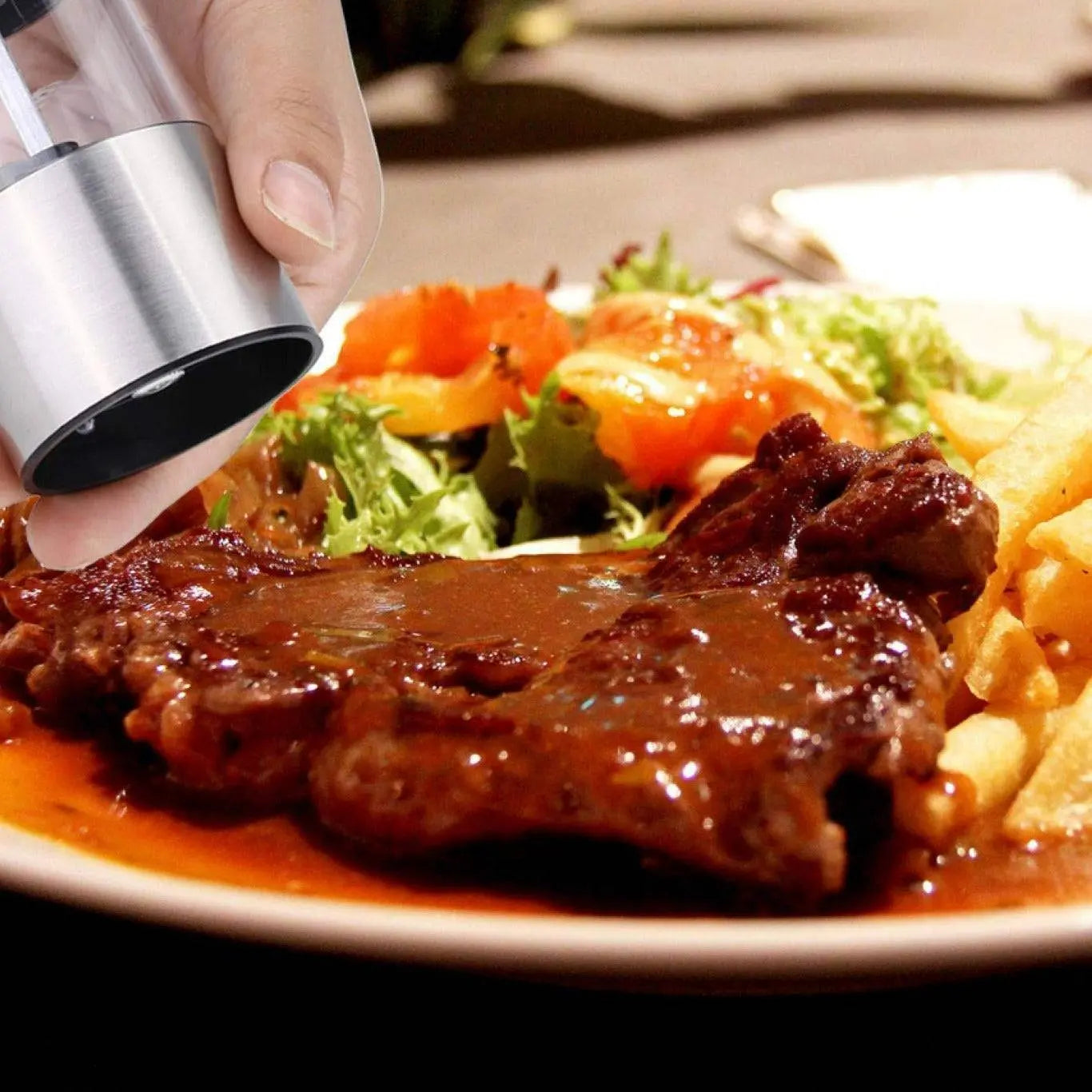 Electric Grinder for Salt & Pepper seasoning a steak dish, highlighting one-touch grinding and adjustable coarseness for effortless meal prep.