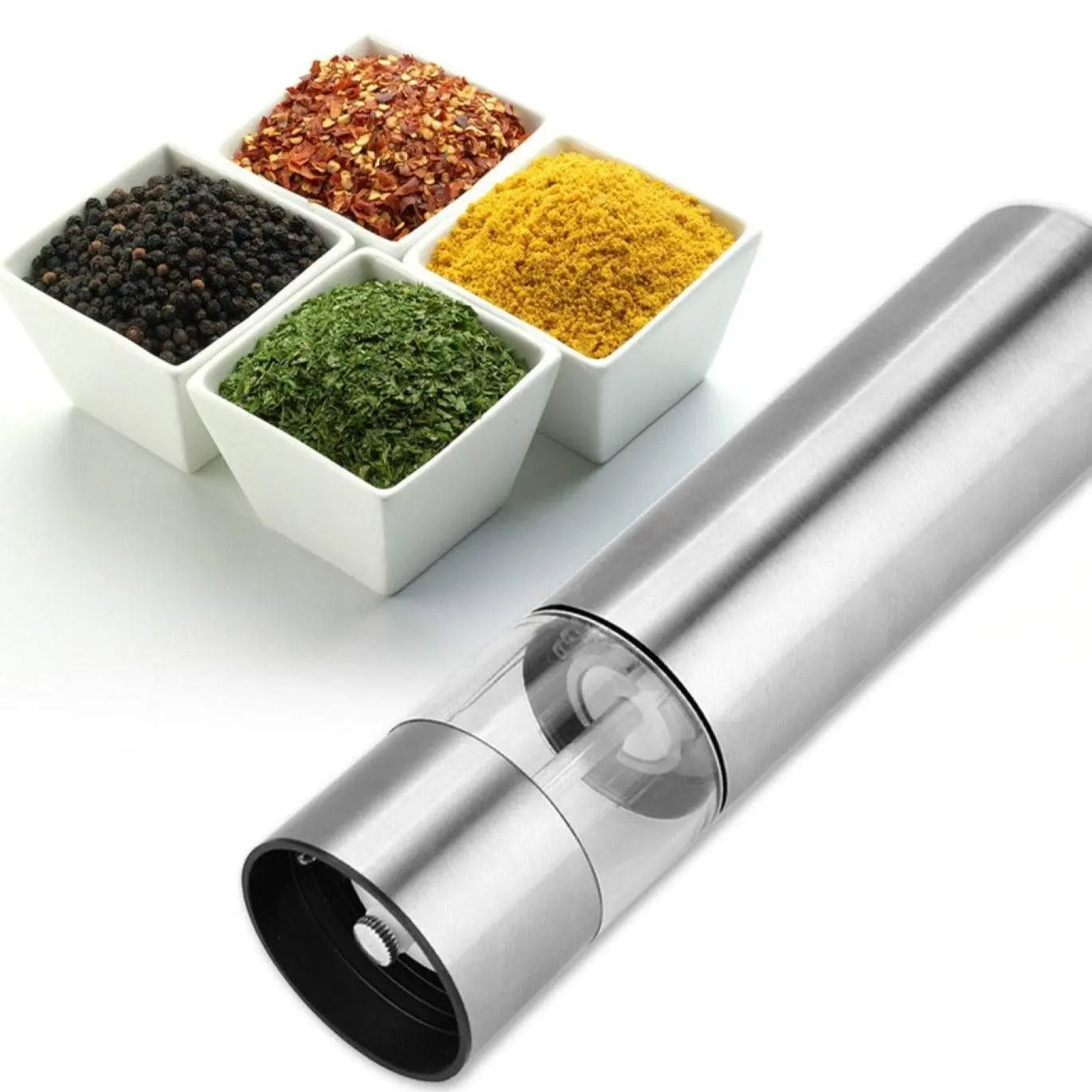 Electric Grinder for Salt & Pepper placed beside assorted spices, emphasizing its stainless steel design and adjustable grinding mechanism.