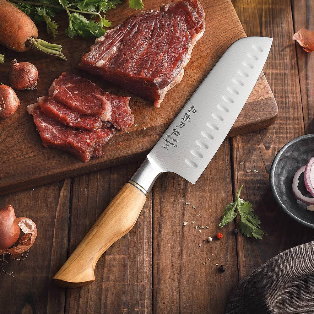 HEZHEN Knife Set - Sandvik Steel Knife Set slicing raw beef on wooden board with ergonomic olive wood handle, Buy 2 Get 1 Free offer.