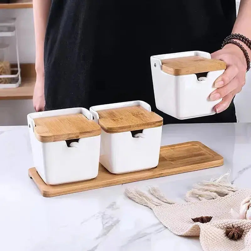 Minimalist Ceramic Spice Jar with Bamboo Lid | Compact & Airtight design shown with a person holding a spice jar over a bamboo tray.