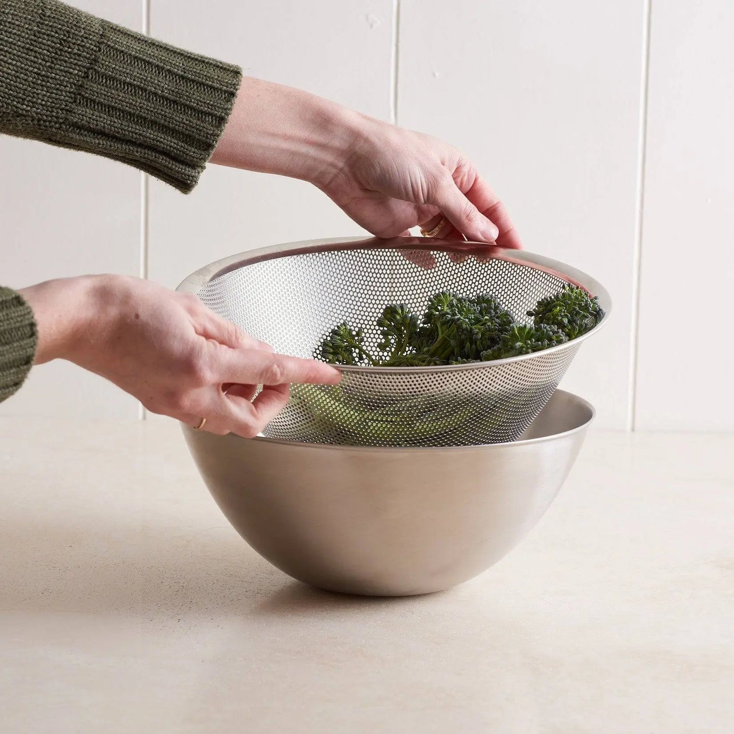 Stainless Steel Mixing Bowls - Non-Slip Kitchen Set paired with a mesh strainer, ideal for washing and draining vegetables efficiently.