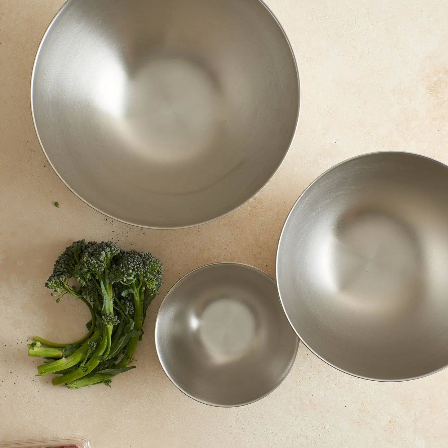 Stainless Steel Mixing Bowls - Non-Slip Kitchen Set displayed in three nesting sizes, offering space-saving storage for any kitchen.