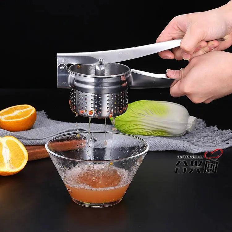 Stainless Steel Manual Juicer - Multifunctional | Compact Design squeezing orange juice into a glass bowl, ideal for healthy lifestyles.