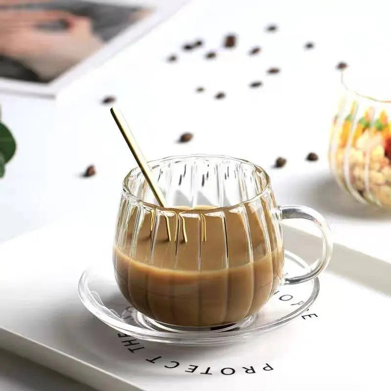 Heat-Resistant Striped Glass Mug with coffee and a gold spoon on a white tray. Durable heat resistant glass mug ideal for hot beverages.