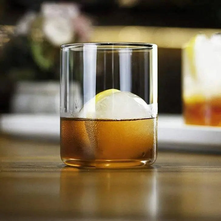 BPA-Free Borosilicate Glasses Set - Durable, Stylish highlighting a single glass with amber drink and large ice sphere, elegant and durable design.