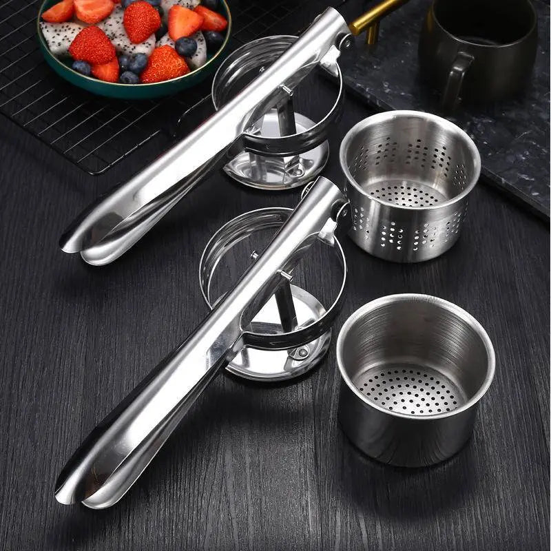 Stainless Steel Manual Juicer - Multifunctional | Compact Design with interchangeable pressing baskets displayed on a black countertop.