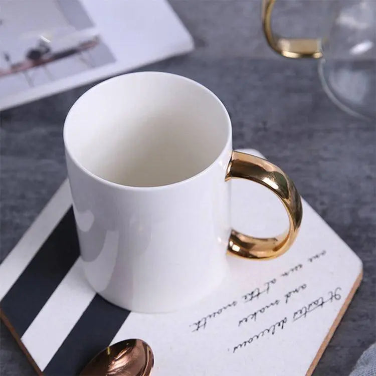 Elegant Coffee Cup with Gold Handle on a striped coaster, showcasing luxurious design perfect for stylish coffee moments.