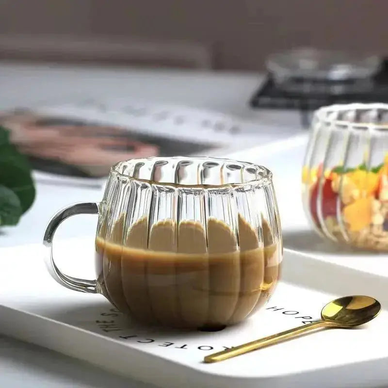 Heat-Resistant Striped Glass Mug containing coffee on a white surface. Chic heat resistant glass mug designed for everyday use.