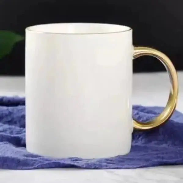Elegant Coffee Cup with Gold Handle placed on a blue cloth, featuring a simple yet luxurious design for stylish coffee breaks.