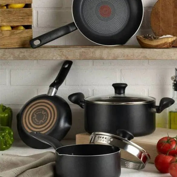 Easy Care Cookware Set - 12 Piece Non-Stick | Durable black pots and pans with glass lids displayed on a kitchen counter, ideal for effortless cooking.
