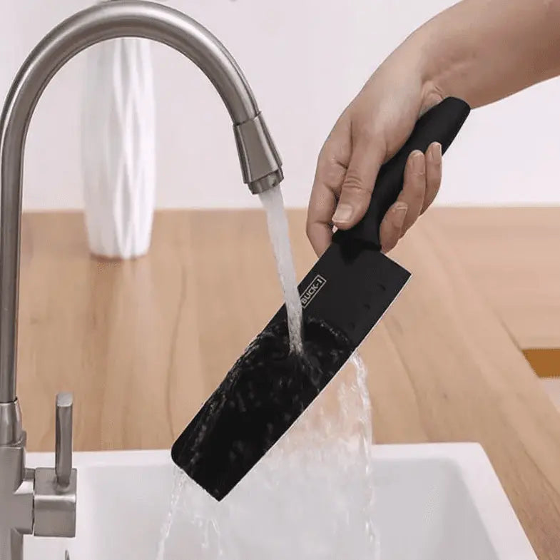 Hand washing a black chef knife from the 8 Pieces Knife Set - 8 Piece Knife Set | Razor-Sharp Knives Combo under a kitchen faucet.