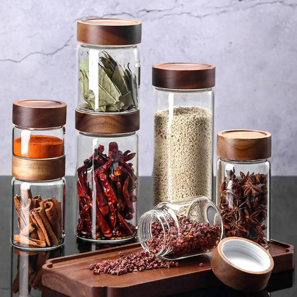 Glass Spice Jars with Wood Lids - Airtight Seal | Buy 2, Get 1 Free featuring assorted spices in clear jars with acacia wood lids for kitchen organization.