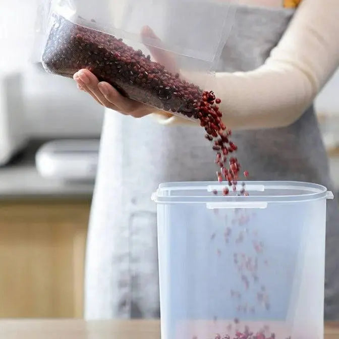 Large Capacity Food Storage Dispenser being emptied into a larger container, demonstrating easy transfer and versatile kitchen organization.