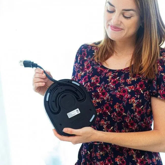 Electric Stainless Steel Kettle - Fast Boiling | Auto Shut-Off, woman holding kettle base showing cord storage underneath for neat organization.