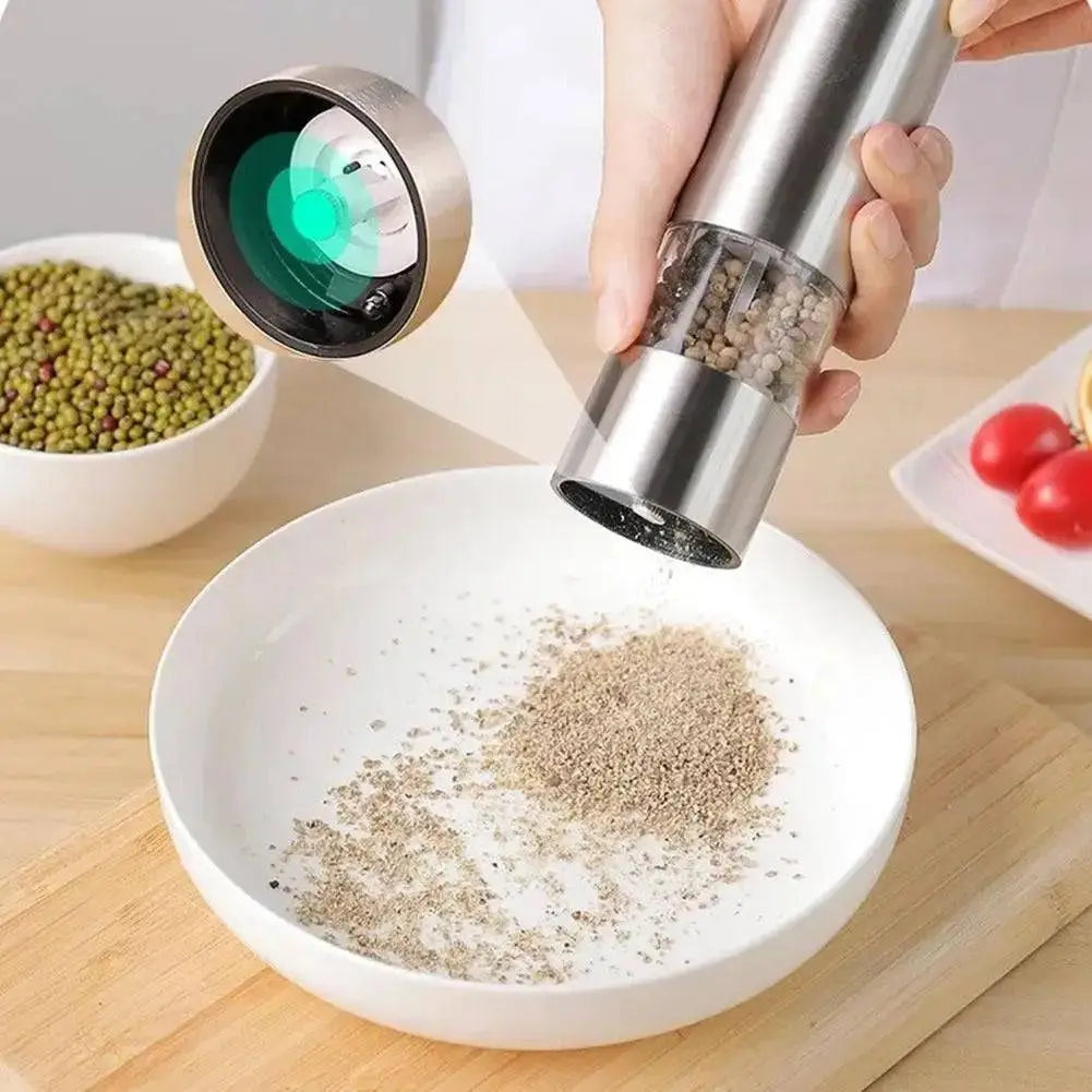 Electric Grinder for Salt & Pepper with one-touch operation grinding pepper onto a white plate, showcasing adjustable coarseness feature.