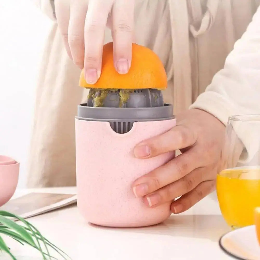Multifunction Fruit Juice Press - Versatile Juice Extraction | No Waste, Easy Clean, shown pressing an orange with a pink container.