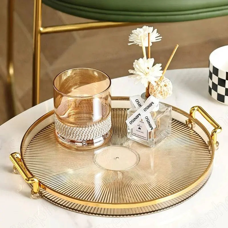 Round Plastic Tray β Stylish Serving Platter featuring a gold-rimmed design, used for displaying a glass and diffuser on a coffee table.