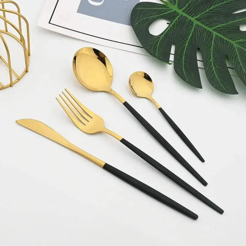 24 Pcs Black Handle Golden Cutlery Set featuring a knife, fork, tablespoon, and teaspoon with sleek black handles and polished golden heads.